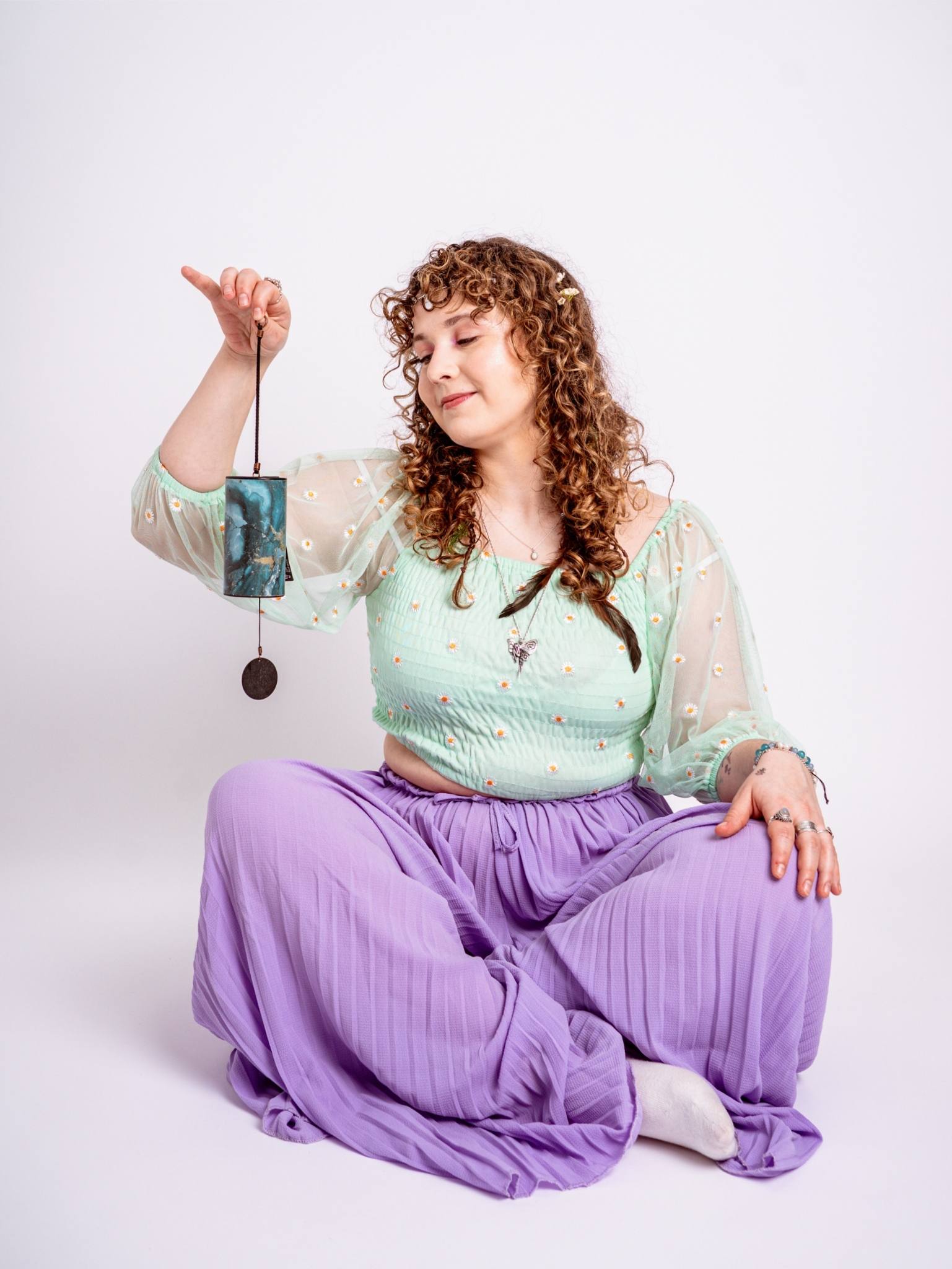 Natalia Ungar sitting cross-legged in a fairy tale outfit.